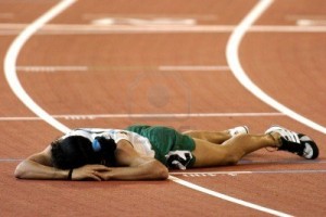 684737-a-runner-is-beaten-and-lays-on-the-track-tired-and-sad-with-defeat