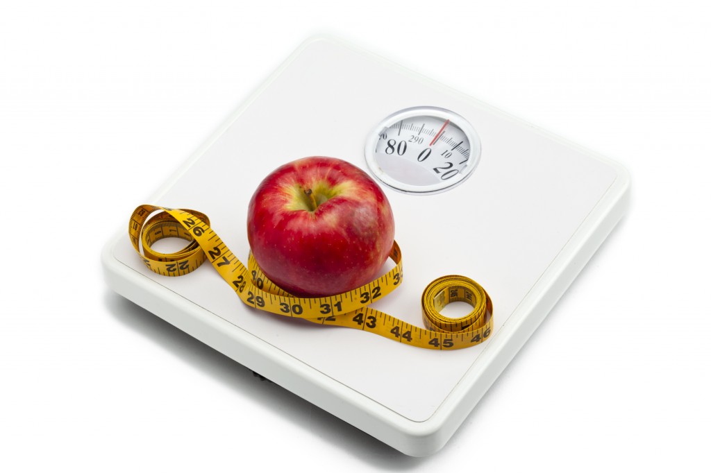weight scale red apple and measuring tape